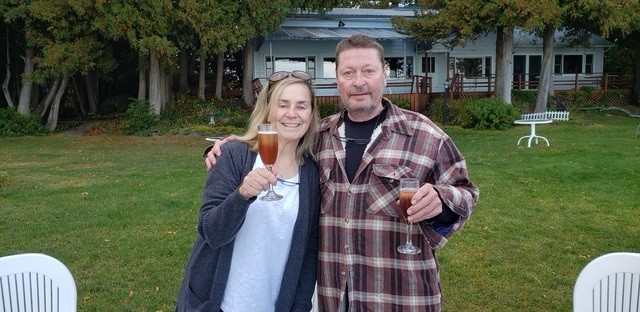 An image showing Mark and Kathy Infante standing together smiling illustrating the history about Ruthcliffe Lodge